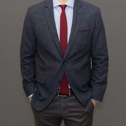 man in black suit jacket and brown pants