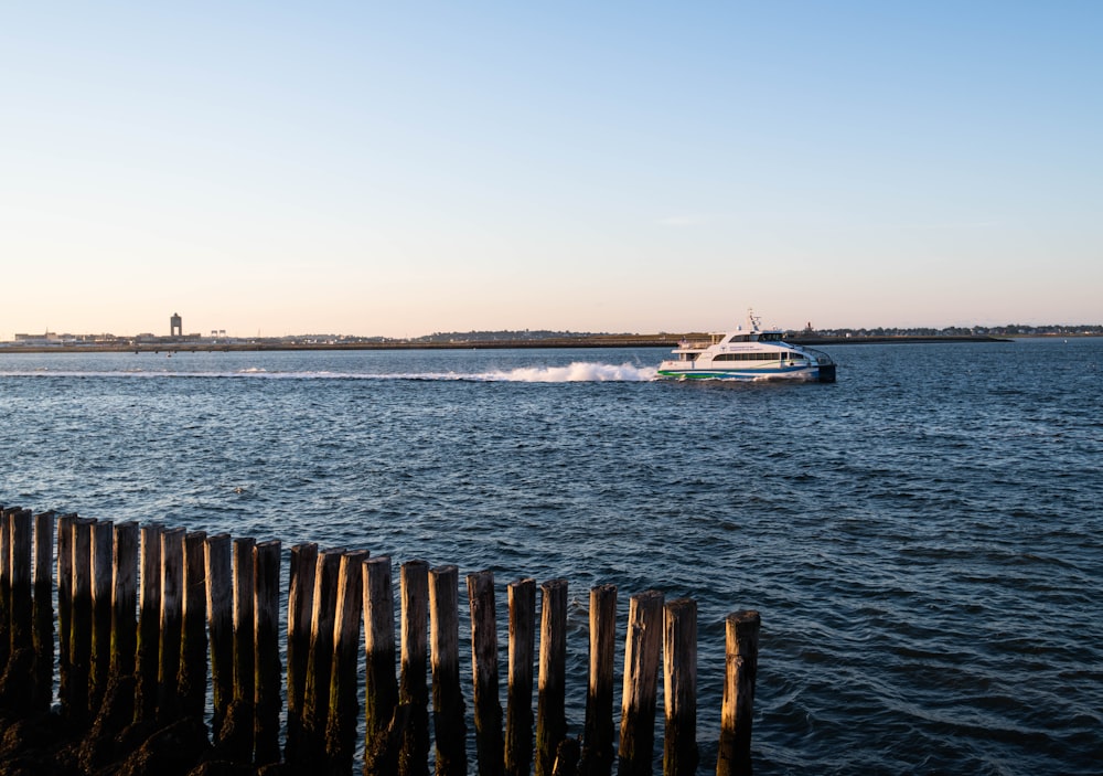 white and blue boat on sea during daytime