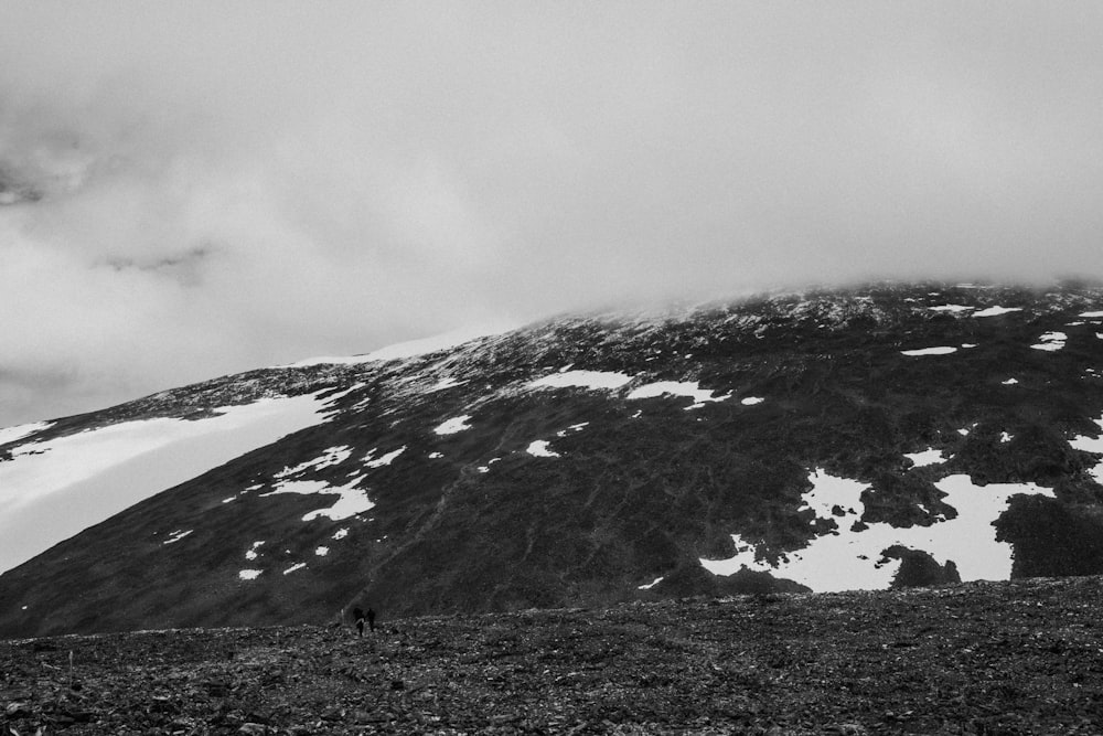 grayscale photo of mountain covered with snow