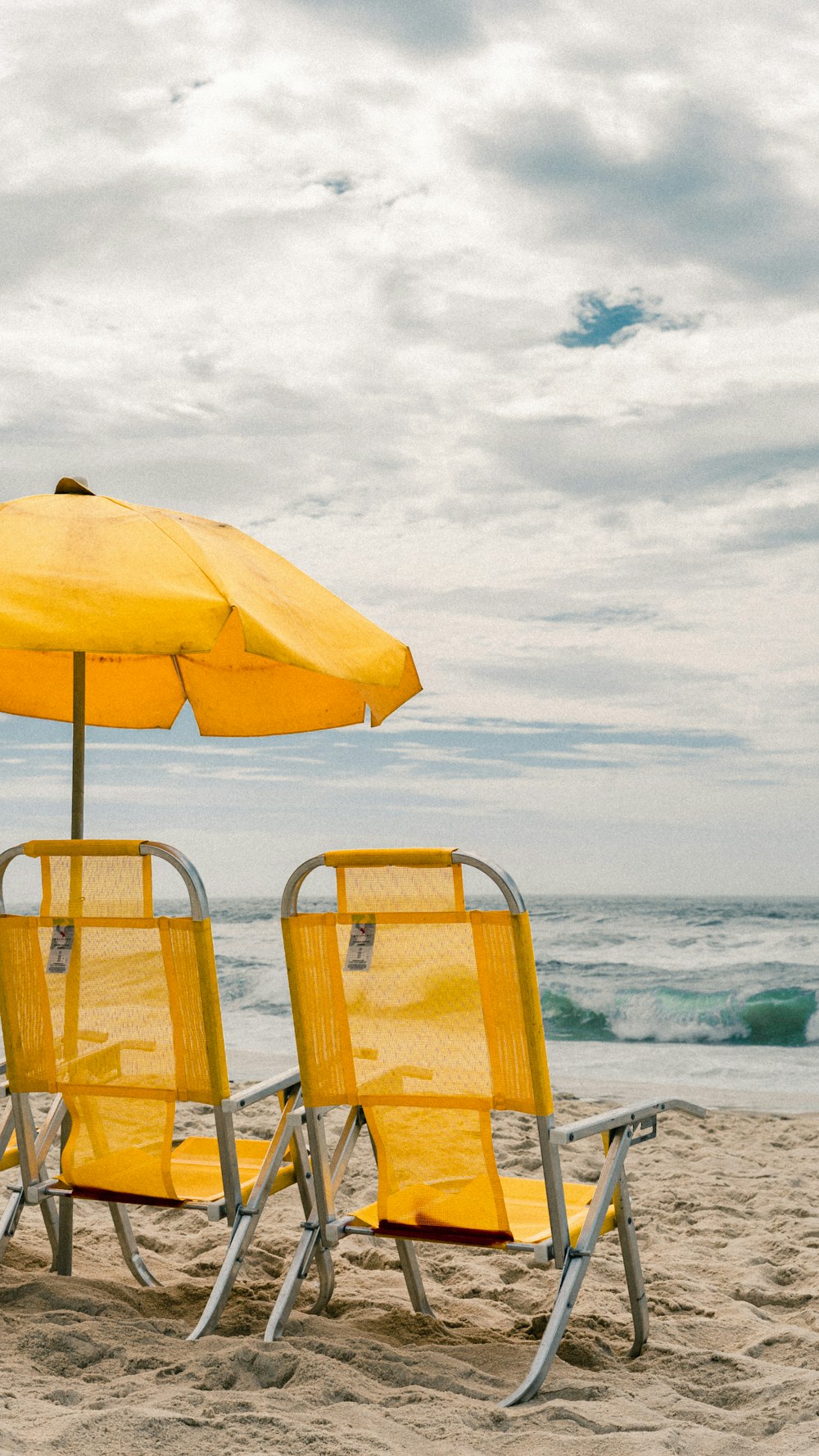 yellow and white patio umbrella on beach during daytime