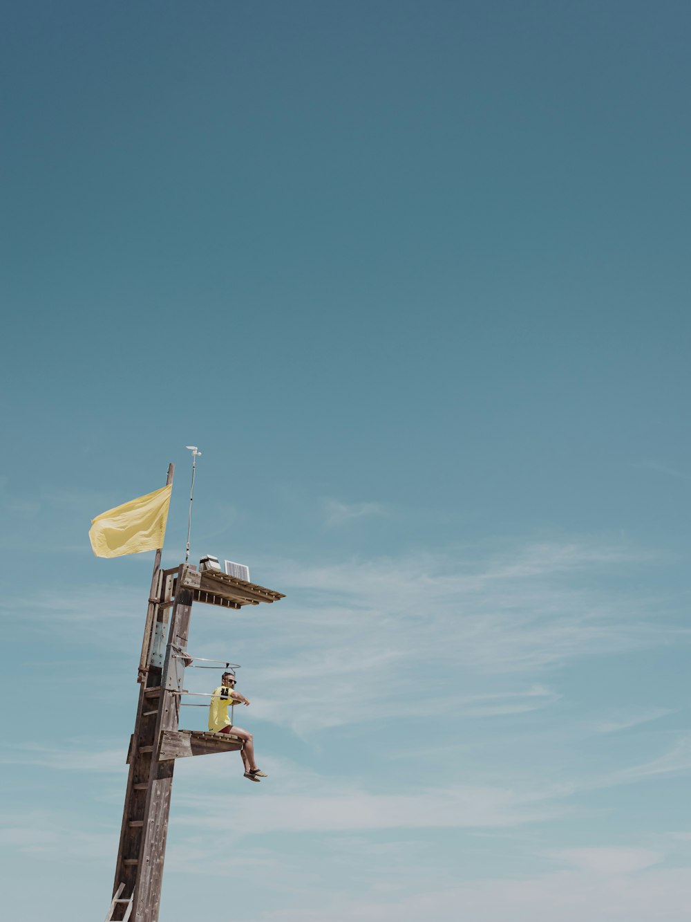 2 men riding on yellow and white plane during daytime