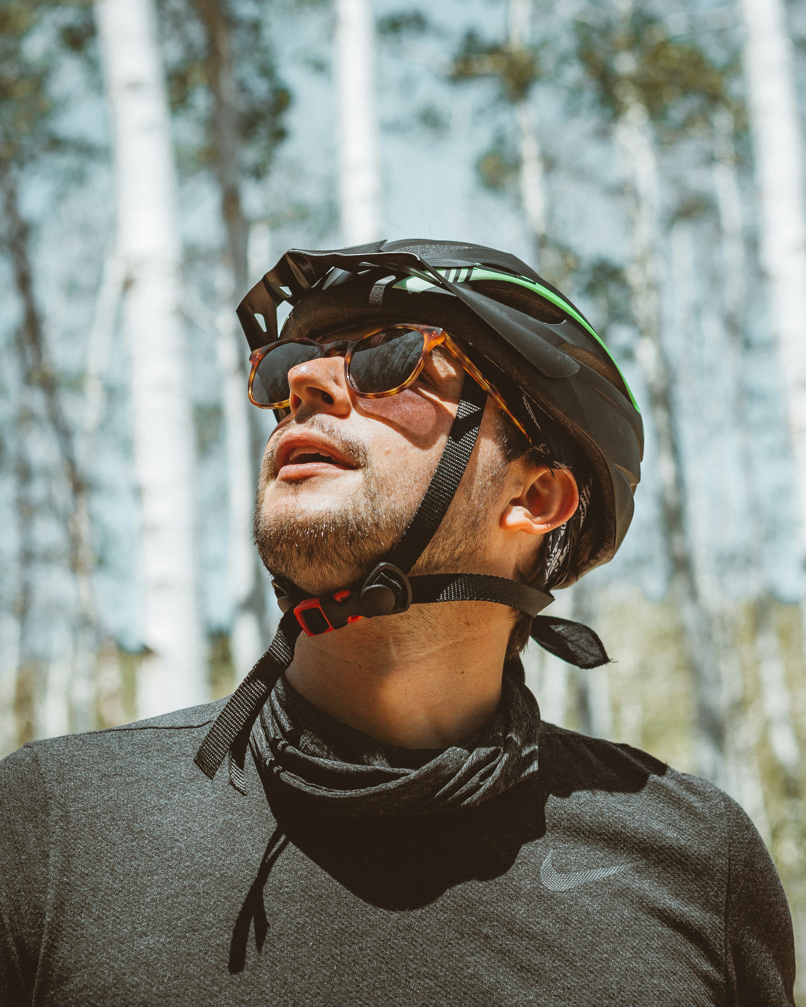 man in gray crew neck shirt wearing black and orange helmet