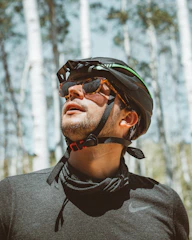 man in gray crew neck shirt wearing black and orange helmet