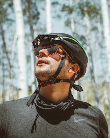 man in gray crew neck shirt wearing black and orange helmet