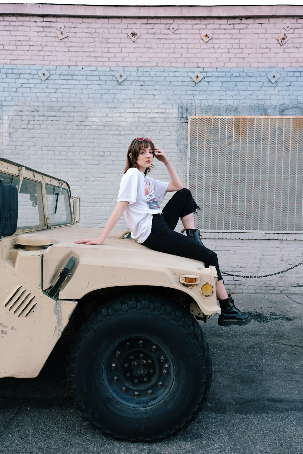 2 women standing beside white car