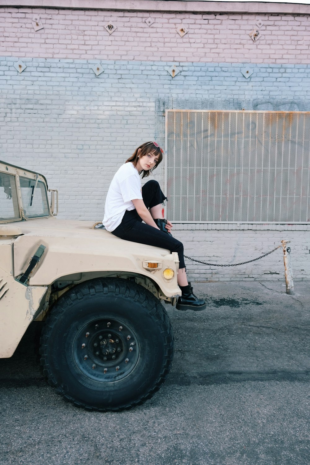 man and woman kissing on white car