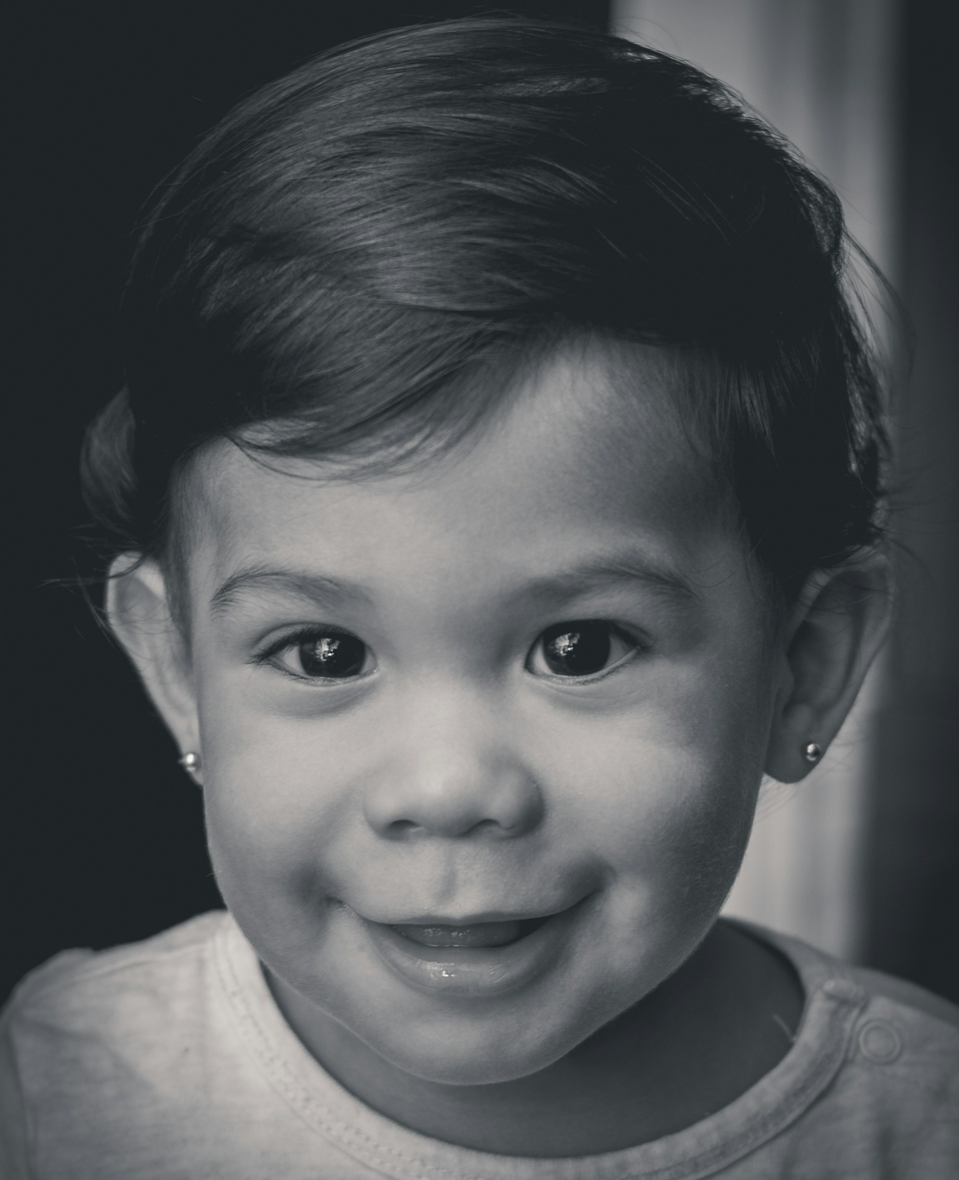 A close-up portrait of a smiling child in a vibrant Nigerian village, showing the joyful impact of a recent cleft lip surgery.