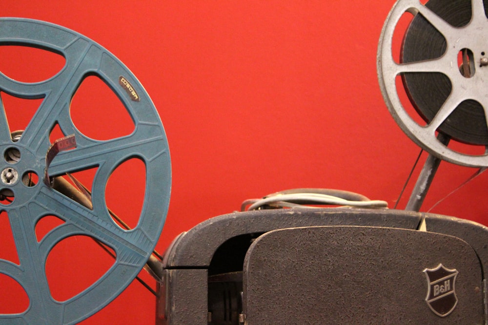 black and gray speaker beside red wall