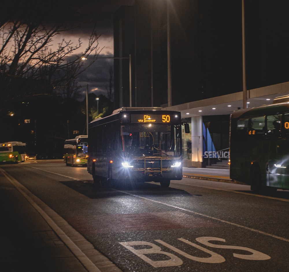 blue bus on road during night time