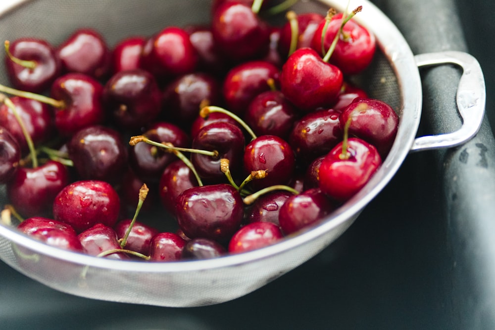 red cherries on white ceramic bowl