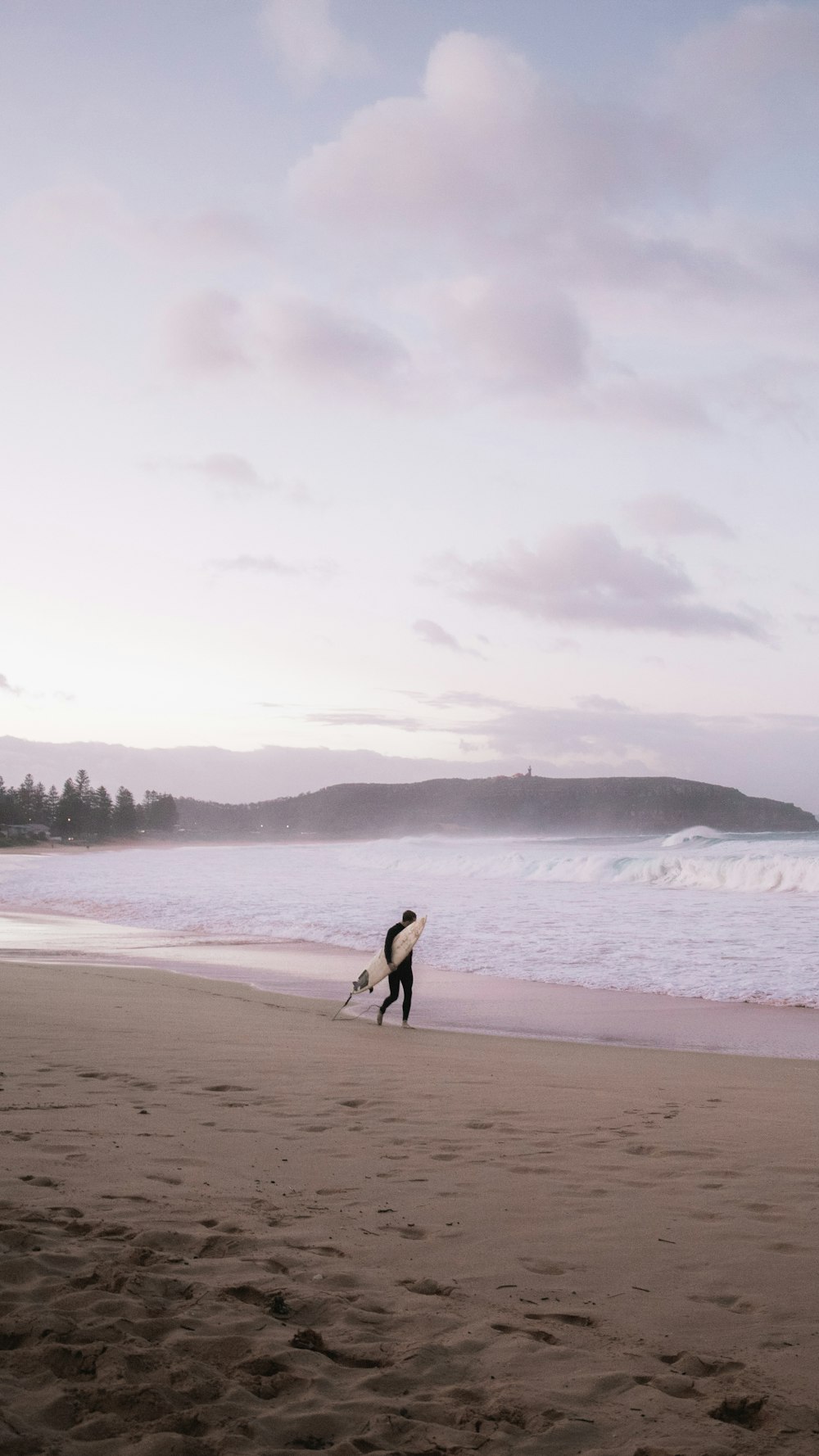 person walking on beach during daytime