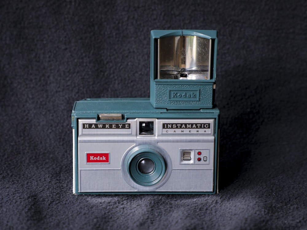 teal and silver point and shoot camera