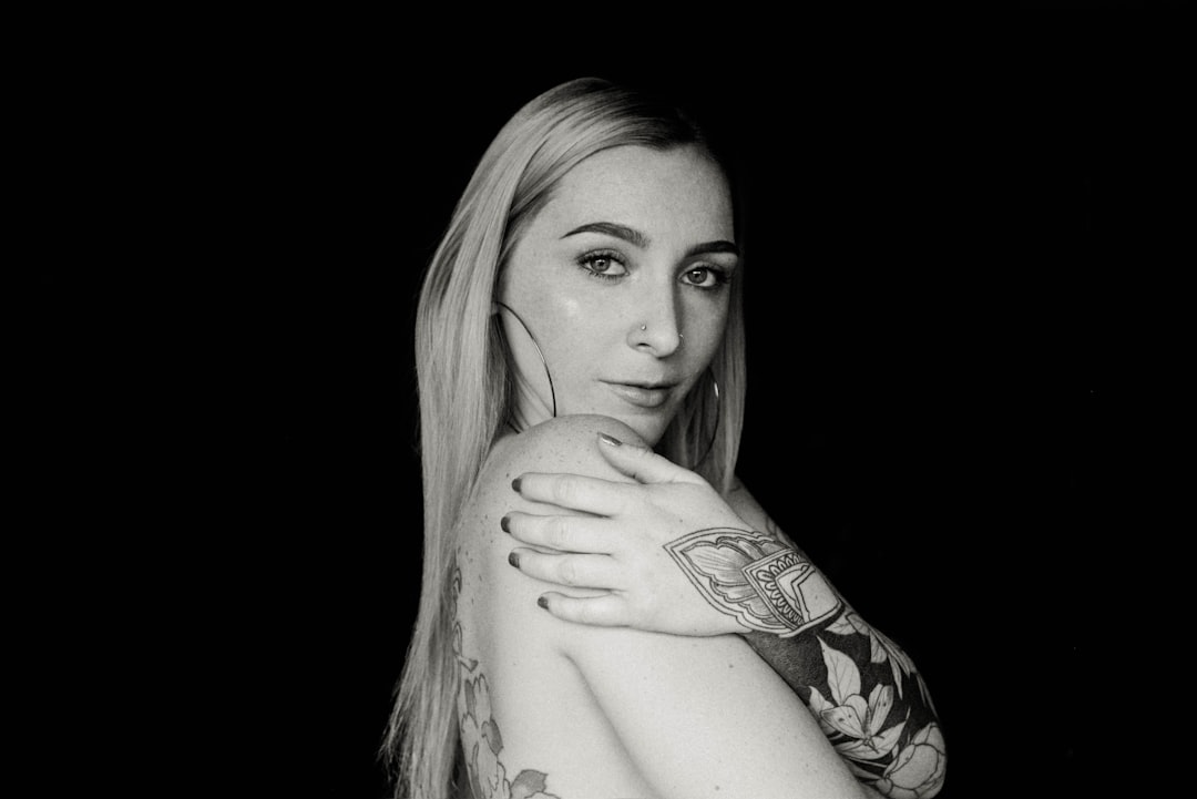 woman with black tattoo on right arm