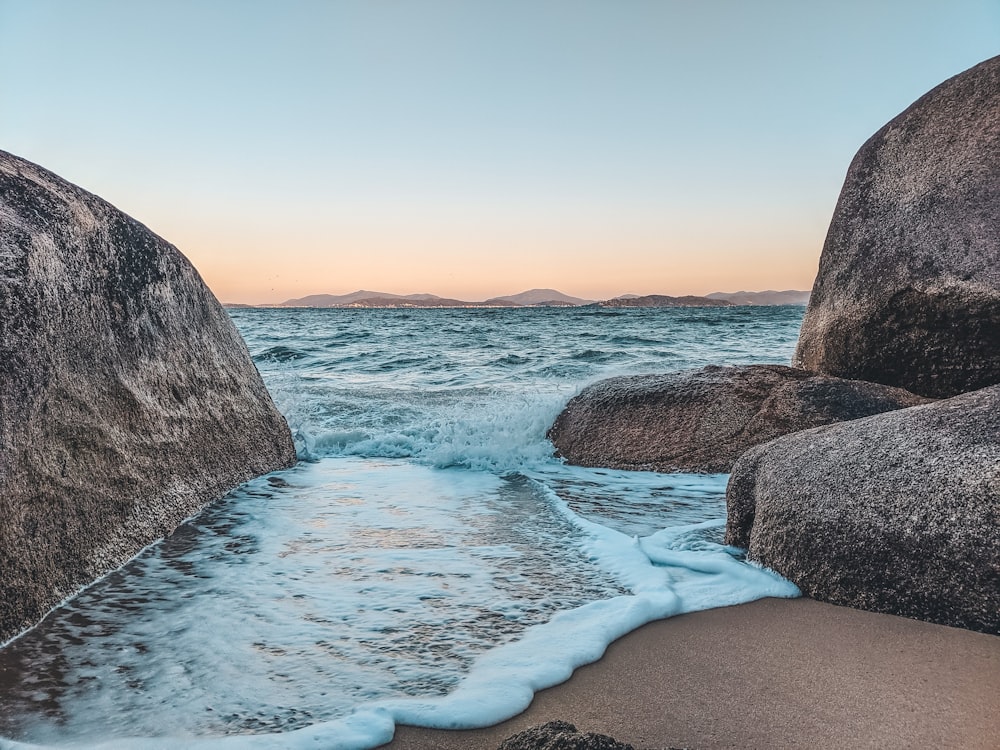 rocky shore with blue sky and white clouds