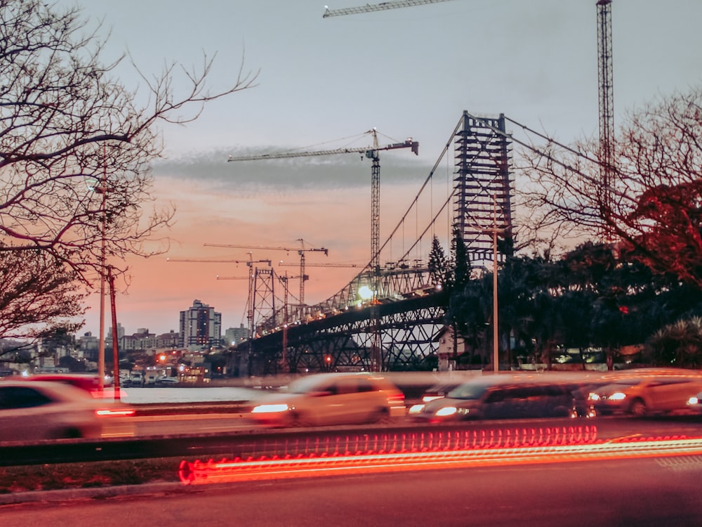 cars on road near bridge during daytime