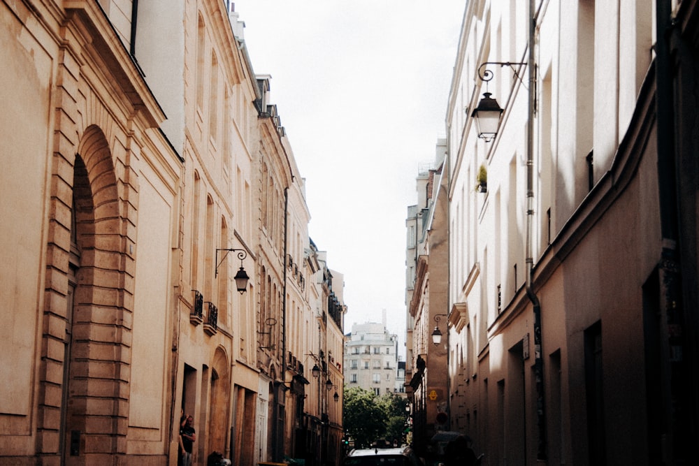 people walking on street between buildings during daytime