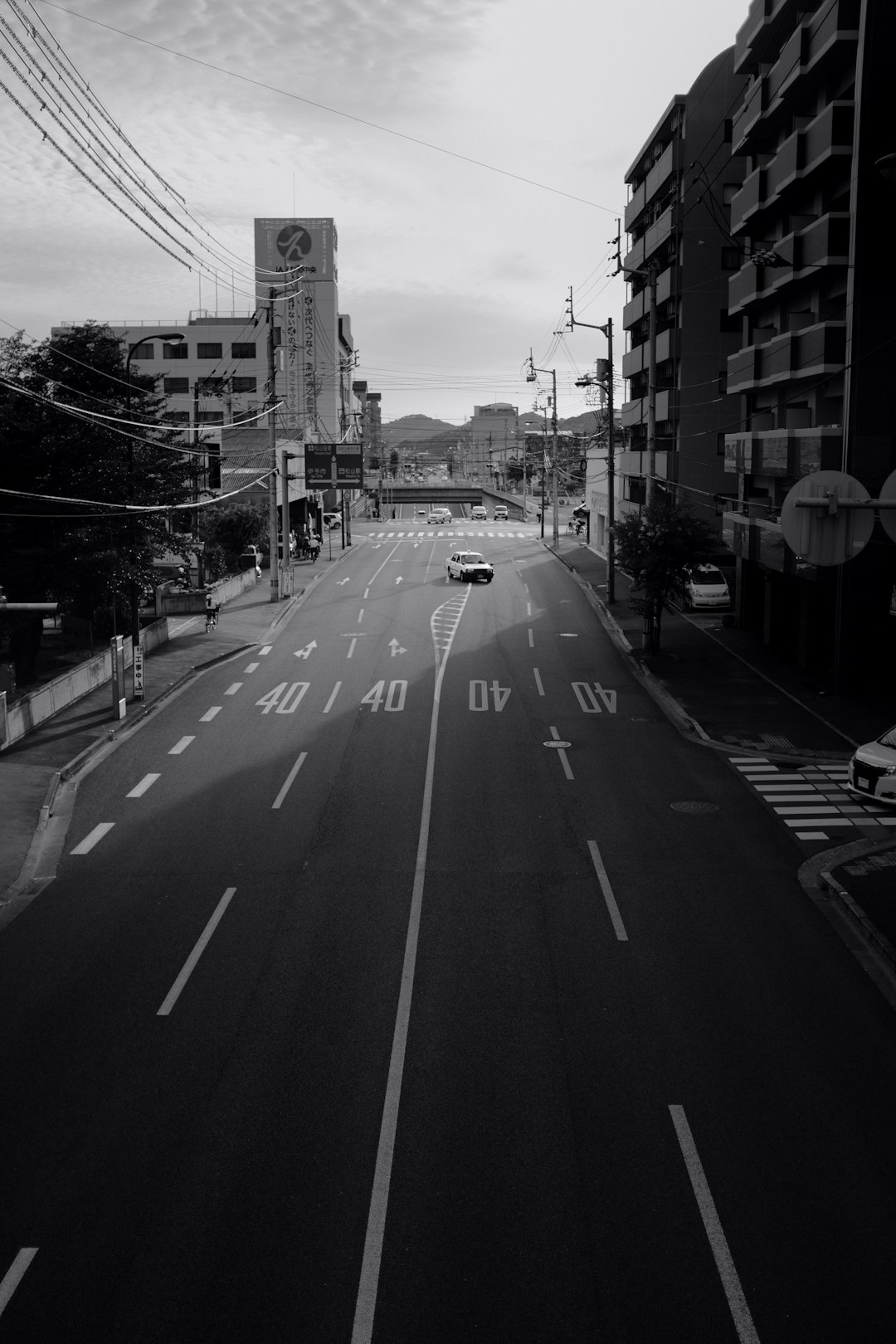 grayscale photo of a road in the city