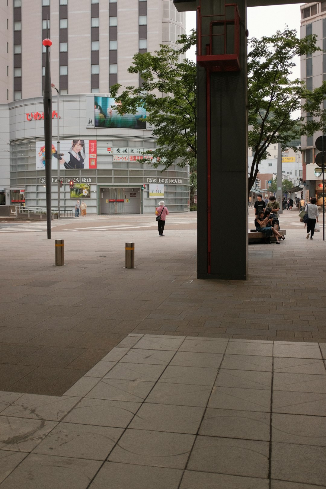 people sitting on bench near building during daytime