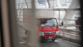 red and white truck on road during daytime