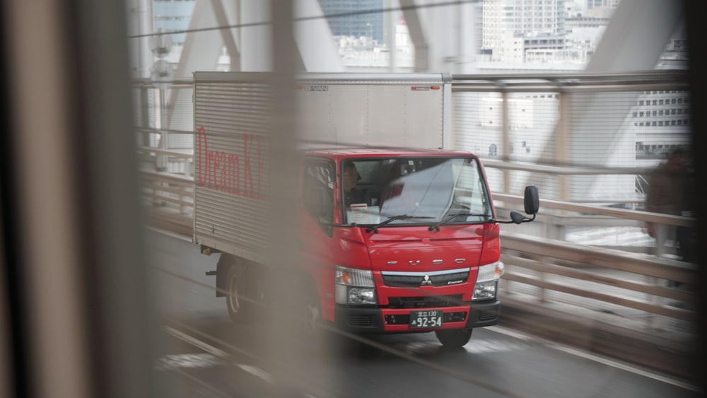 red and white truck on road during daytime