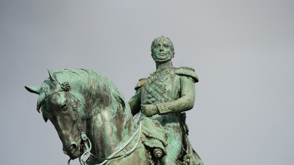 man riding horse statue during daytime
