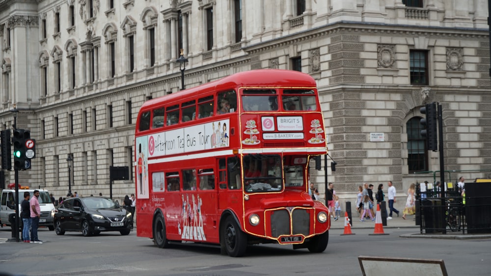 red double decker bus on road during daytime