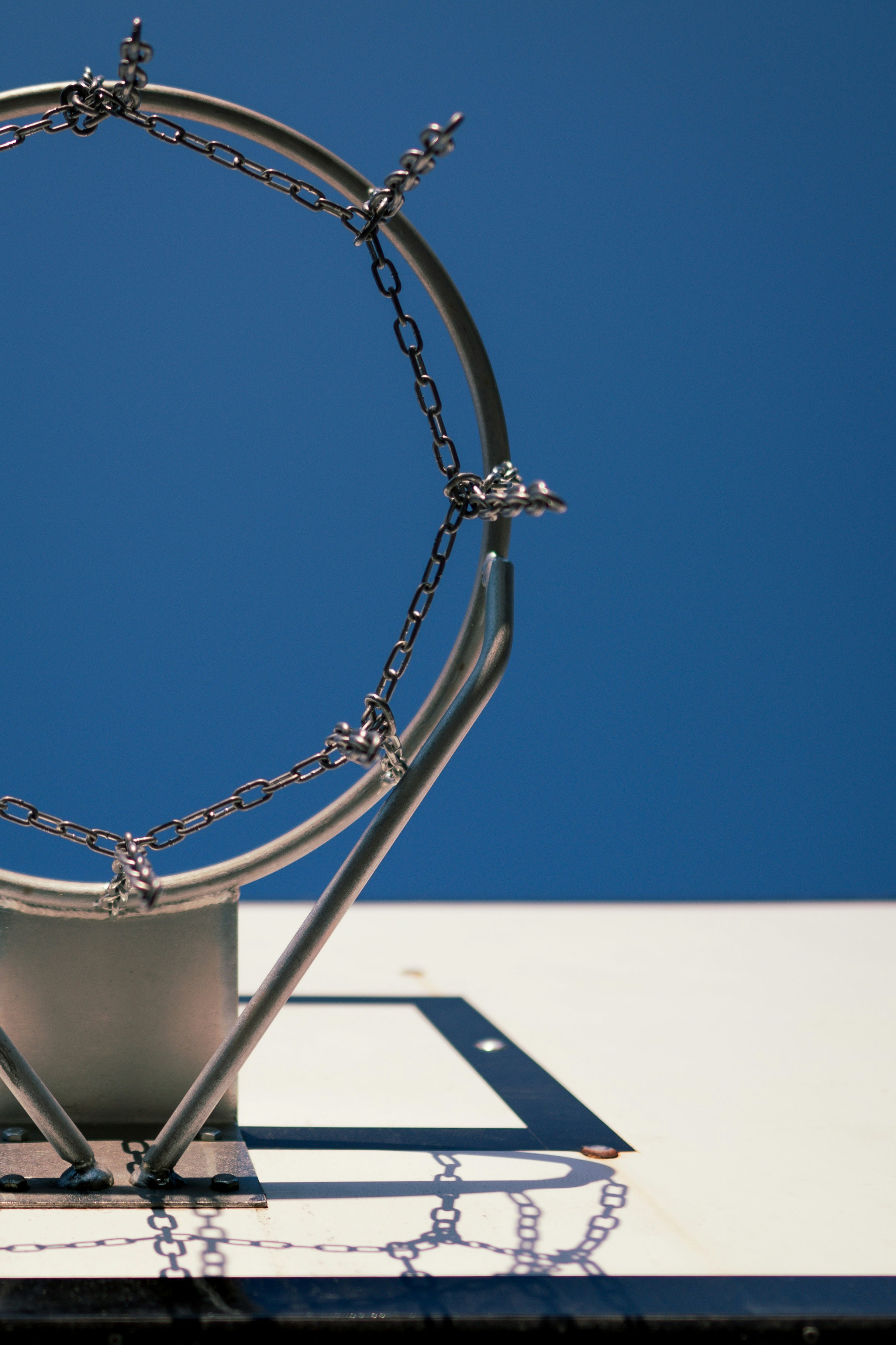 silver chain necklace on white table
