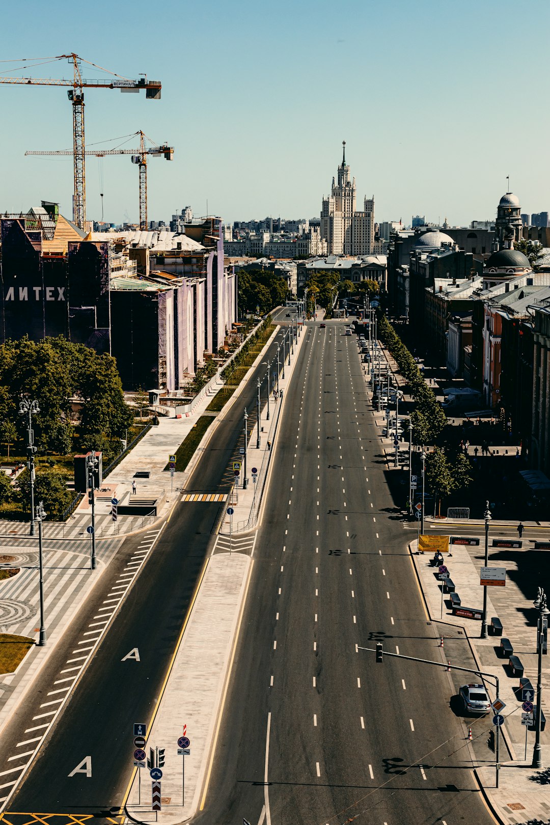 cars on road near city buildings during daytime