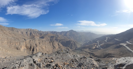 brown rocky mountain under blue sky during daytime in Ras al Khaimah - United Arab Emirates United Arab Emirates