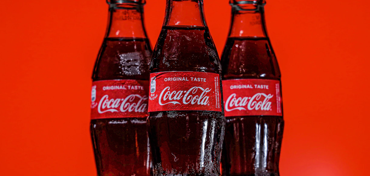 coca cola bottles on black table