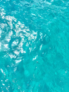 Photo capturing a sleek jetski cutting through crystal-clear Adriatic waters under a bright blue sky.