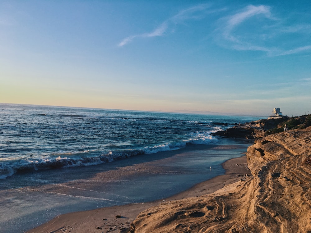 ocean waves crashing on shore during daytime