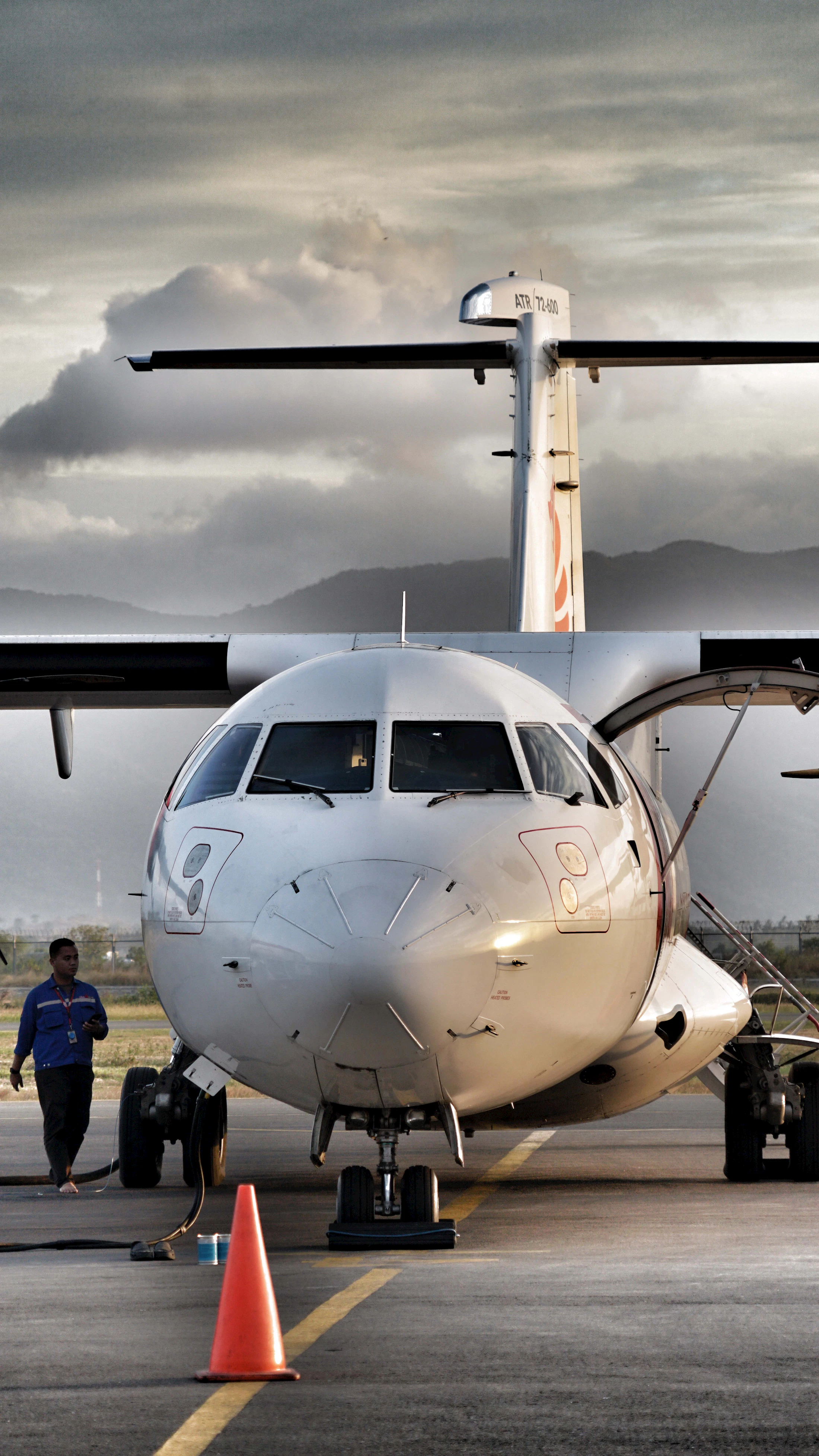 Ground crew walking beside a commercial aircraft