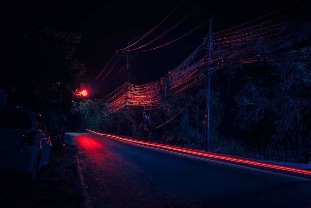 red and white light streaks on road during night time