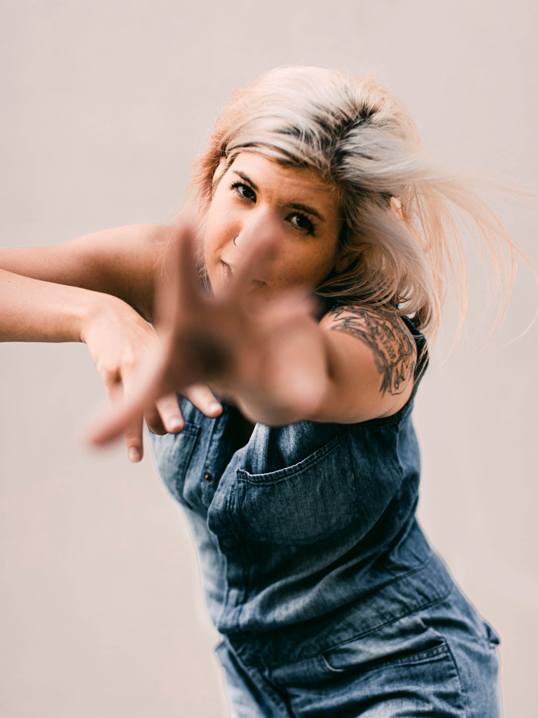 woman in blue denim sleeveless shirt