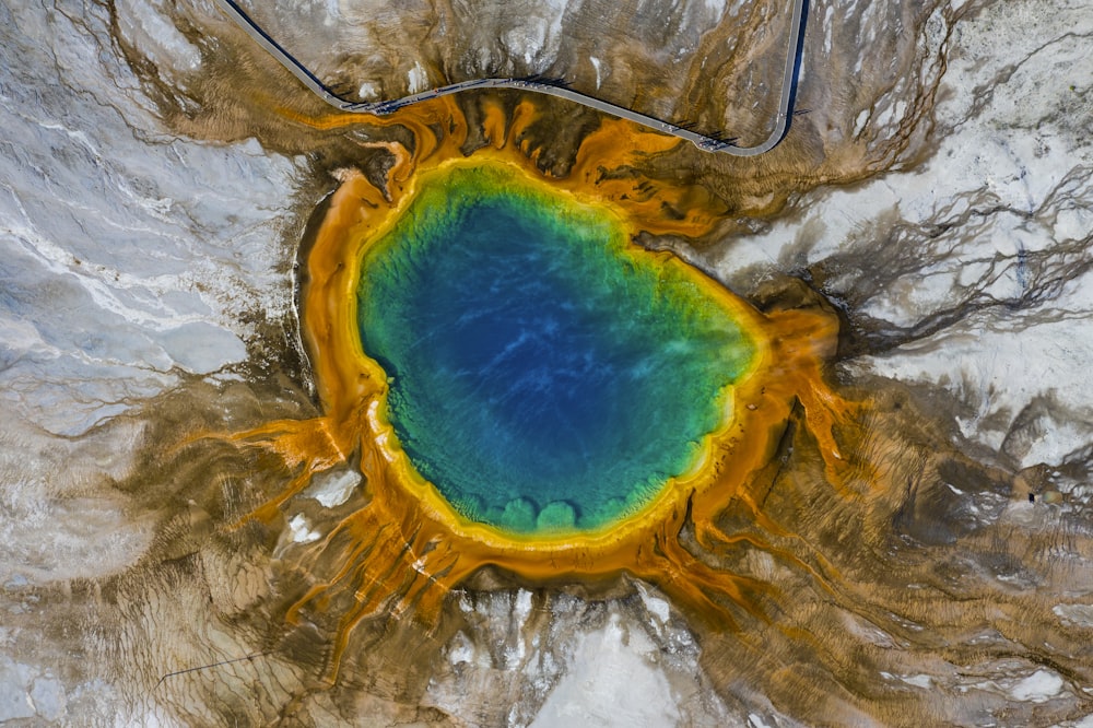 blue and yellow water on brown and gray surface