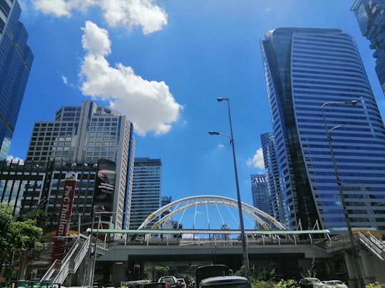 white and black concrete building under blue sky during daytime in Sathorn Thailand