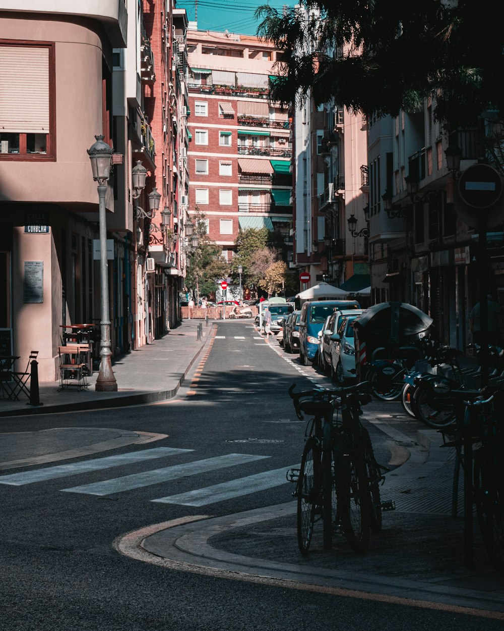 cars parked on sidewalk near buildings during daytime