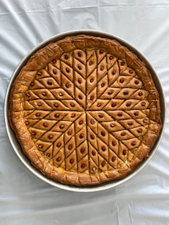 brown pie on white textile