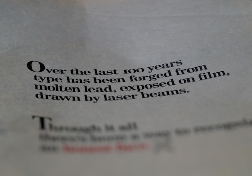 Text printed on paper with a focus on the evolution of typography over the last century, mentioning molten lead and laser beams.