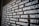 A close-up of a wall or board covered with various words in bold white letters, each conveying different emotions or concepts, on a dark background. The perspective is slightly angled, adding depth.