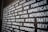 A close-up of a wall or board covered with various words in bold white letters, each conveying different emotions or concepts, on a dark background. The perspective is slightly angled, adding depth.