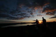 A scenic sunset over Lago Chungara with silhouettes of community members.