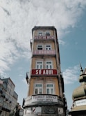 red and white concrete building under white clouds during daytime