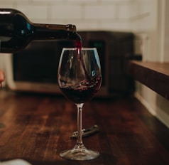 clear wine glass on brown wooden table