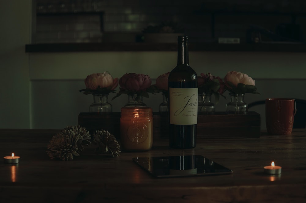 black glass bottle on brown wooden table