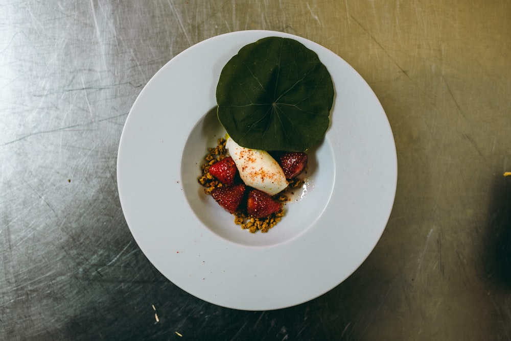 green leaf on white ceramic plate