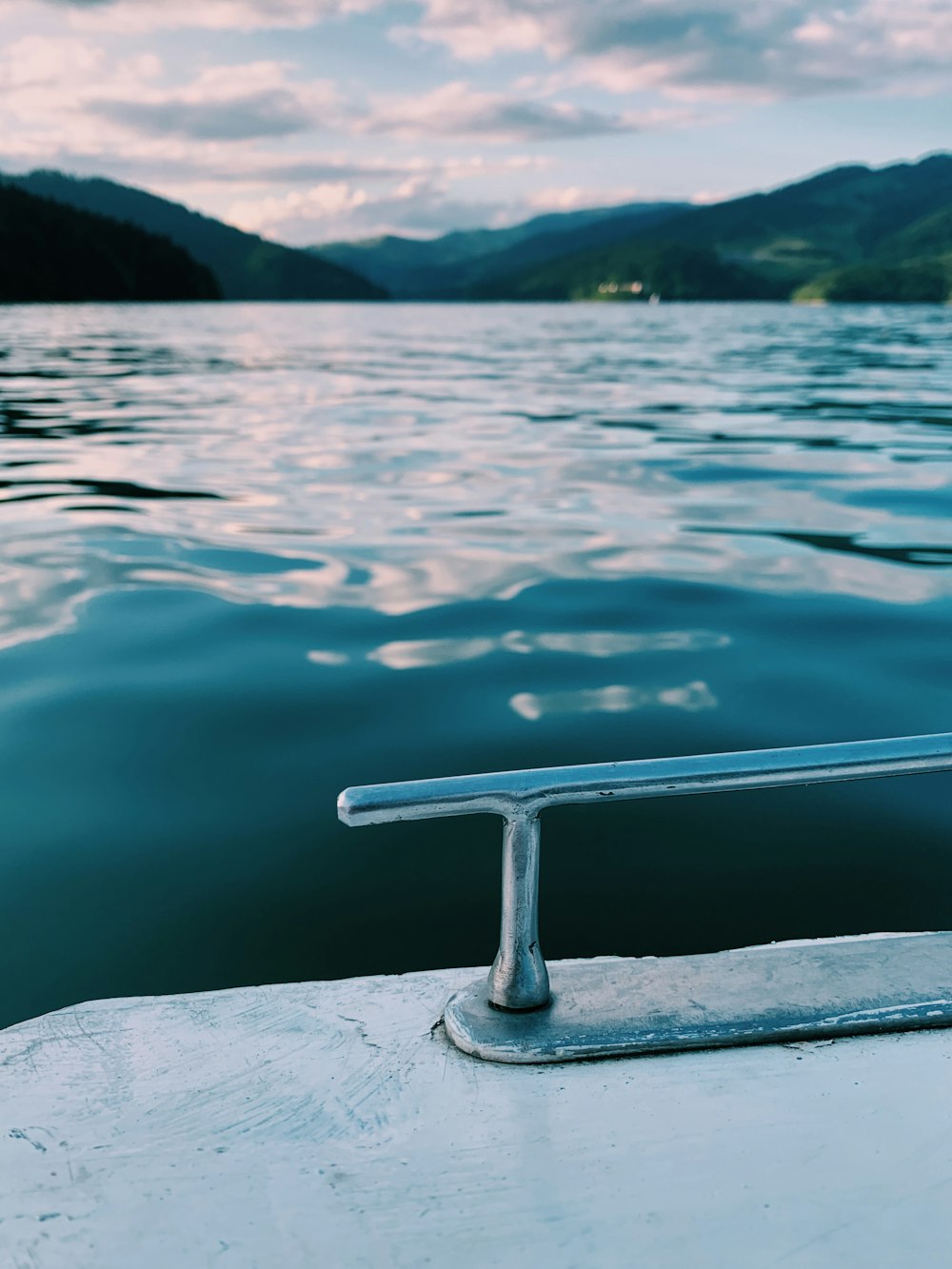 body of water near mountain during daytime