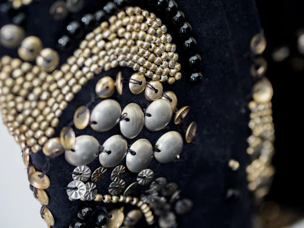 A close-up photograph capturing intricate beadwork on a traditional African-inspired textile.