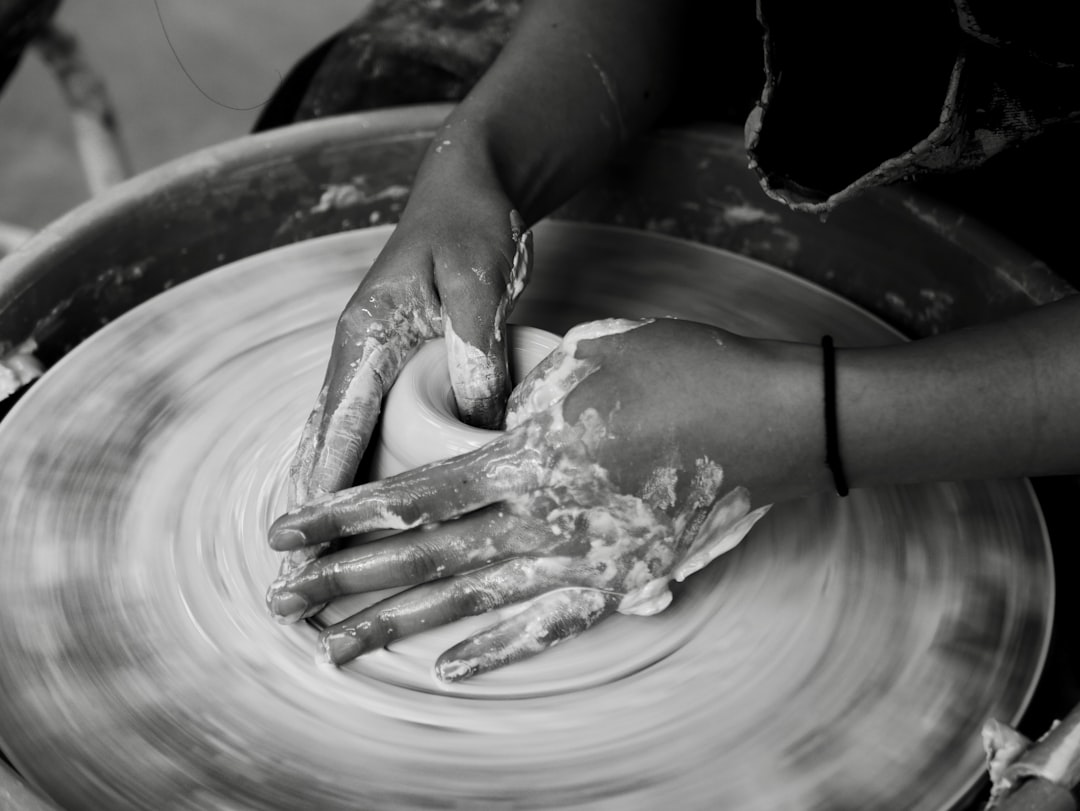 person holding green leaf on gray round plate